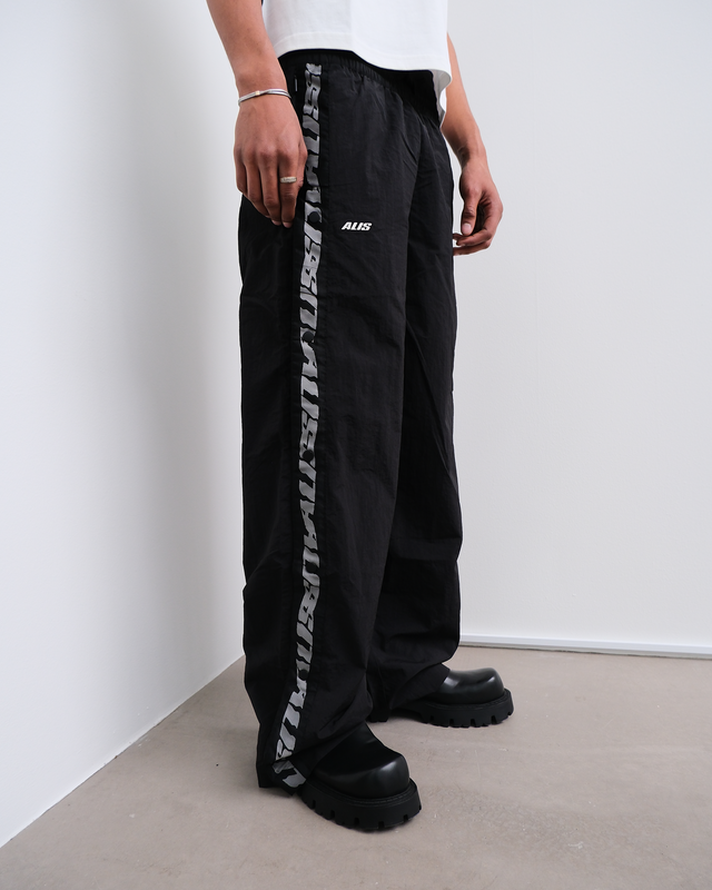 ALIS TEEFEY TRACK PANTS W/ LOGO TAPE Track pants